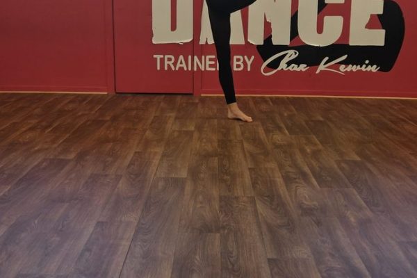 Got2Dance dancer holding a high leg extension