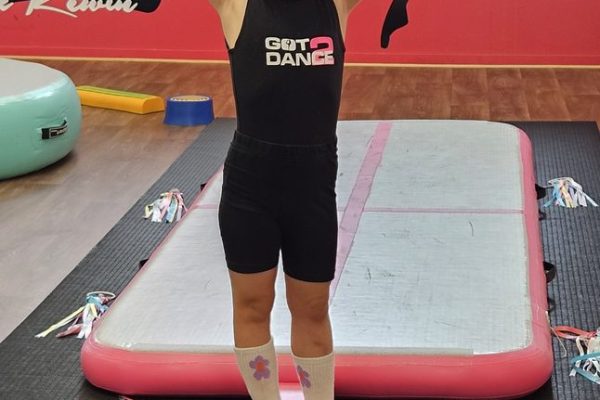 Toddler balancing on the beam in a Got2Dance Tumble Time class
